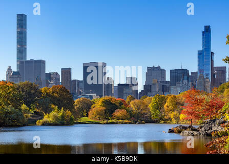 Fall in Central Park by the Lake with Midtown skyscrapers. New York City Stock Photo