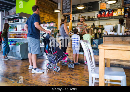Patrons at a coffee shop in a large metropolitan city Stock Photo
