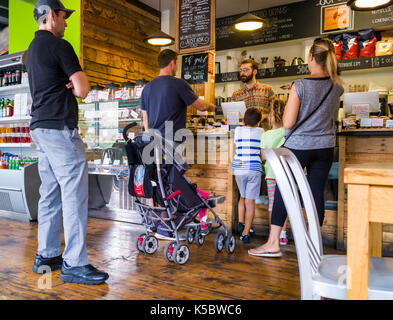 Patrons at a coffee shop in a large metropolitan city Stock Photo