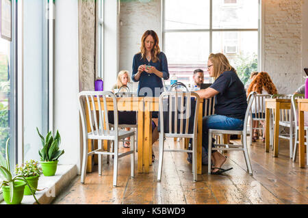 Patrons at a coffee shop in a large metropolitan city Stock Photo