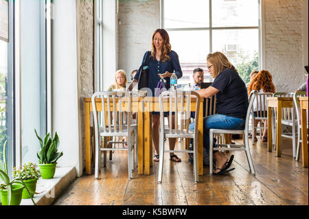 Patrons at a coffee shop in a large metropolitan city Stock Photo