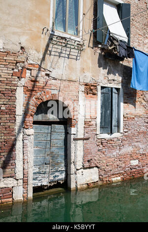 Venice, Wenedig, Wenecja - an old medieval city on water, between canals. View from a sail boat or from the bridges. Stock Photo