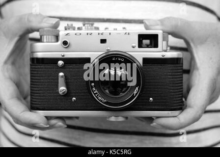 Woman holding vintage Zorki Russian rangefinder camera Stock Photo