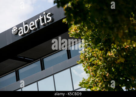 A logo sign outside of the headquarters of Abertis Infraestructuras in ...
