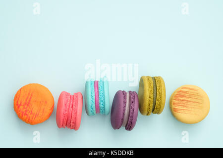 colorful macaroons on turquoise background, Sweet and tasty for cooking and restaurant menu, Dessert beautiful, Top view, Space to write. pastel color Stock Photo