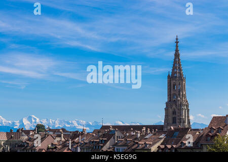 Bern cathedral with alps in background Stock Photo