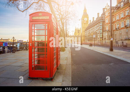 London, England - Traditional Old British red telephone box at Victoria Embankment with Big Ben at background Stock Photo