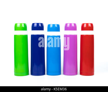 Green, blue, pink and red thermos bottles on white background with copy space Stock Photo