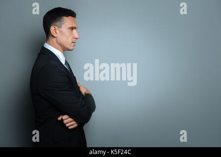 Serious nice man looking in front of him Stock Photo