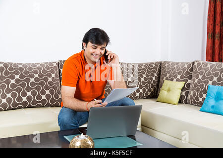 Business man Checking Reading Contract Paper Talking Phone at home Stock Photo