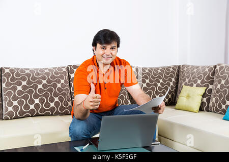 Indian Businessman Checking Contract Paper Dealing Success Thumbsup At home Stock Photo
