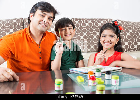 happy family father and children son and daughter draw paints Stock Photo