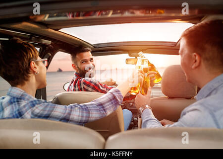 Young friends enjoying a road trip in the car Stock Photo