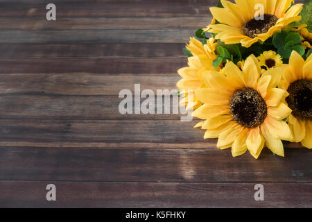 Sunflower Bouquet on dark brown wooden background with lots of copy space. Stock Photo