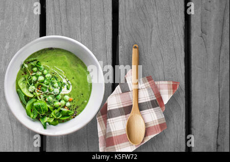 Pea soup on wooden table Stock Photo