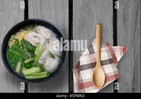 Wonton noodle soup on wooden table Stock Photo