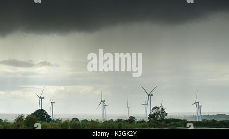Henlow, Bedfordshire, Wind turbines with heavy dark grey weather in the background. Stock Photo