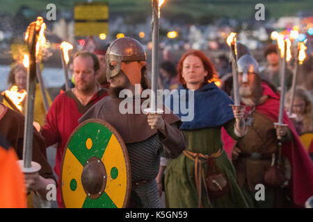 Vikings torchlight parade march in Largs, Scotland, UK.  September, 2017. The Battle of Largs 02 October 1263 a Re-enactment of pagan festival event by the Swords of Dalriada, 13th Century, living history group.  It was an indecisive engagement between the kingdoms of Norway and Scotland, on the Firth of Clyde near Largs, Scotland. The Viking conflict formed part of the Norwegian expedition against Scotland in 1263, in which Haakon Haakonarson, King of Norway attempted to reassert Norwegian sovereignty over the western seaboard of Scotland. Stock Photo