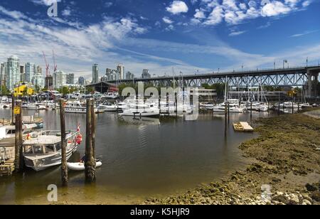 Landscape View of Granville Bridge, Fisherman Wharf, Granville Island and Marina from False Creek Seawall in Vancouver British Columbia Canada Stock Photo