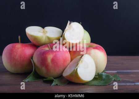 bio apples sliced on wooden table Stock Photo