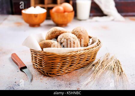 fresh bread in basket and on a table Stock Photo