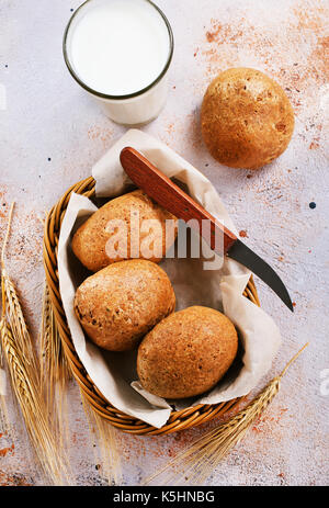 fresh bread in basket and on a table Stock Photo