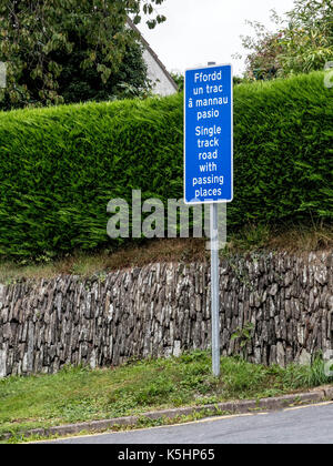 Blue and white sign in Welsh and English advising that the road ahead is a single track with passing places Stock Photo