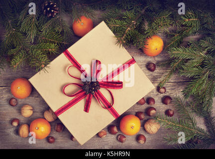 Christmas composition with a gift box, tangerines, nuts and spices. view from above Stock Photo