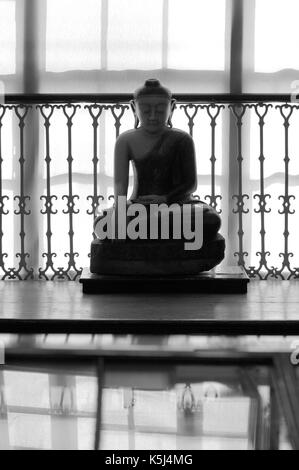 A marble statue of Buddha from Burma, Myanmar. Thought to be from 18th or 19th century it is now displayed in the Wisbech and Fenland  Museum. Stock Photo