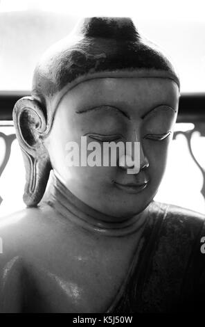 A marble statue of Buddha from Burma, Myanmar. Thought to be from 18th or 19th century it is now displayed in the Wisbech and Fenland  Museum. Stock Photo