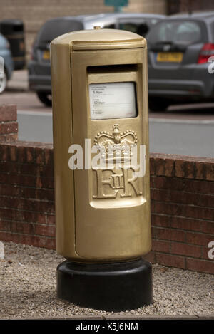 Royal Mail postbox painted gold to celebrate an Olympic sucess on the roadside in Nailsworth Gloucestershire England UK. August 2017 Stock Photo