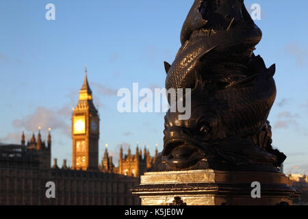 Vulliamy dolphin lamp on Albert Embankment , Big Ben and Palace of Westminster in background, London, England Stock Photo