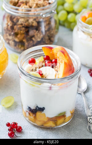 Natural yogurt with fresh fruits, berries and oat granola. Healthy breakfast food, diet fitness lifestyle concept. Closeup view Stock Photo