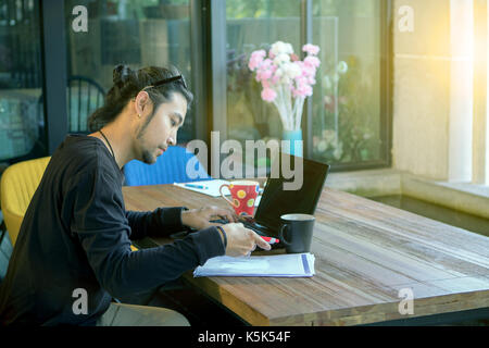 freelance man working on laptop computer in home office Stock Photo