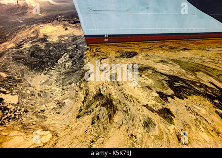 Oil spill from the ship - Texture of crude oil spill on the water. Stock Photo