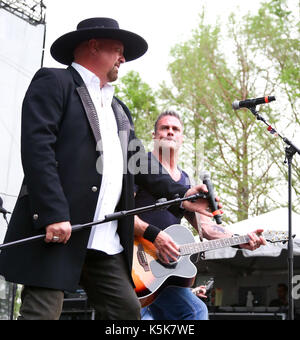 Eddie Montgomery (L) and Troy Gentry of Montgomery Gentry Perform during the ACM Party For A Cause Festival on April 17, 2015 in Arlington, Texas. Stock Photo