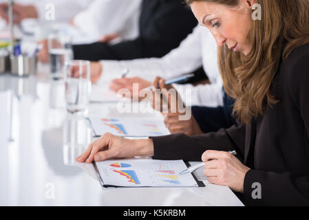 Close-up Of Businesswoman Analyzing Graph In Office Stock Photo