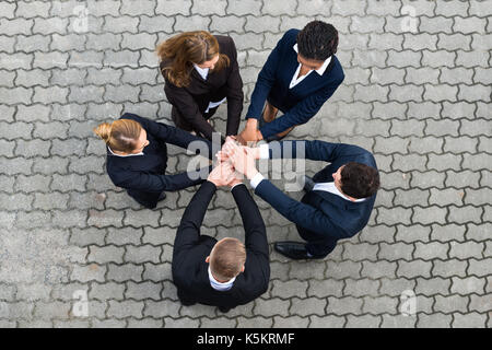 High Angle View Of Businesspeople Stacking Hands Stock Photo