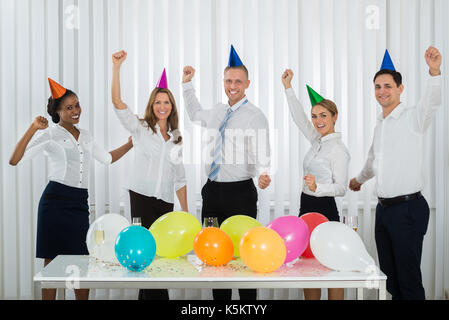 Group Of Happy Businesspeople Celebrating Success During Party In Office Stock Photo