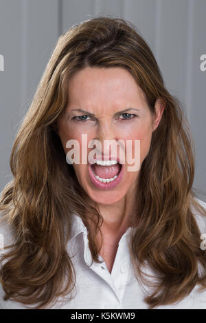 Portrait Photo Of Angry Mature Woman Screaming Stock Photo