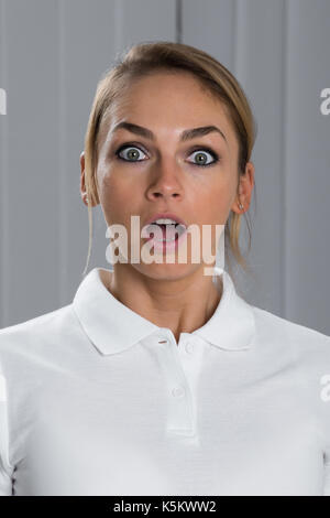 Portrait Of Surprised Young Beautiful Woman In White T-shirt Stock Photo