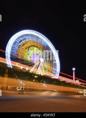 Ferris Wheel long exposure with car light trails Stock Photo