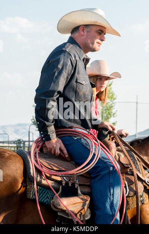 Cowboy and cowgirl in saddle vertical released Stock Photo