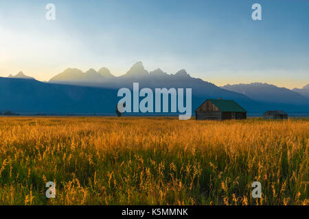 A part of the T. A. Moulton barn at sunset with the Grand Teton Range in the background inside Grand Teton National Park, Wyoming, United States (USA) Stock Photo