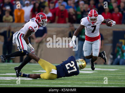 South Bend, Indiana, USA. 09th Sep, 2017. Georgia running back D'andre Swift (7) runs with the ball as Notre Dame cornerback Julian Love (27) attempts to make the tackle during NCAA football game action between the Georgia Bulldogs and the Notre Dame Fighting Irish at Notre Dame Stadium in South Bend, Indiana. Georgia defeated Notre Dame 20-19. John Mersits/CSM/Alamy Live News Stock Photo