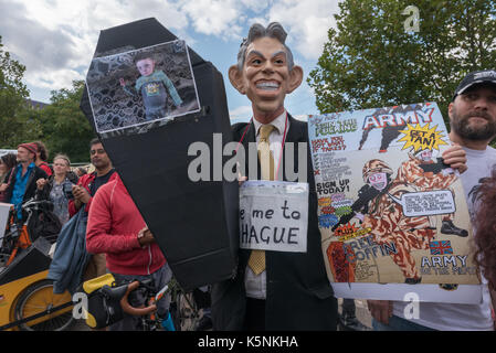 London, UK. 9th Sep, 2017. London, UK. 9th September 2017. A man wearing a Tony Blair mask holds a small coffin and a poster about the army at the East gate of the worlds's largest arms fair, DSEI, the Defence & Security Equipment International, backed by the UK government where arms companies and arms dealers sell weapons to countries around the world including many repressive regimes. He was one of several hundred protesters who blocked the road to hold up lorries entering the site. Police tried to clear the road and made several arrests including two who had formed a lock-in and ano Stock Photo