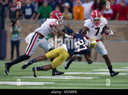 South Bend, Indiana, USA. 09th Sep, 2017. Georgia running back D'andre Swift (7) runs with the ball as Notre Dame cornerback Julian Love (27) attempts to make the tackle during NCAA football game action between the Georgia Bulldogs and the Notre Dame Fighting Irish at Notre Dame Stadium in South Bend, Indiana. Georgia defeated Notre Dame 20-19. John Mersits/CSM/Alamy Live News Stock Photo