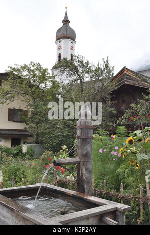 water feature with Garden and Church tower in background Stock Photo