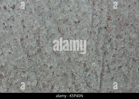 Background from concrete with impregnations from red granite gravel with an uneven surface Stock Photo