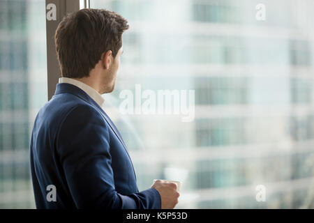 Businessman thinking about decision in office Stock Photo
